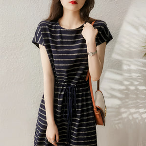 Navy striped short sleeve midi dress with a belted waist, worn by a woman.
