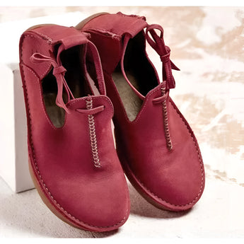 Men's navy suede chukka boots with red accents, displaying a stylish and modern design, crafted from leather.
