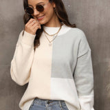 Neutral tone color-block sweater in gray, size XL, worn by a smiling woman pairing it with jeans and sunglasses.
