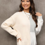 Neutral tone color-block sweater featuring long sleeves and a relaxed fit. The sweater showcases a modern design with a high neckline and color-block pattern, ideal for women's fall fashion.