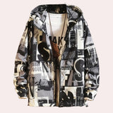 Black and white shirt with newspaper print design, featuring bold typographic elements, displayed on a hanger. The shirt has a classic collar and short sleeves, showcasing a modern fashion style.
