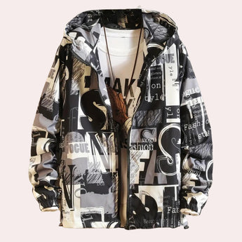 Black and white shirt with newspaper print design, featuring bold typographic elements, displayed on a hanger. The shirt has a classic collar and short sleeves, showcasing a modern fashion style.