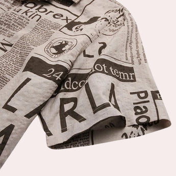 Newspaper print shirt featuring a modern vintage urban design with short sleeves and a bold newspaper pattern.