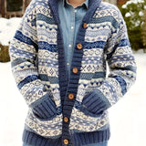 
A chunky knit wool-blend cardigan featuring a Nordic pattern in blue, black, and grey colors, with a tartan-inspired design. The cardigan has a high neck, long sleeves, and a cozy collar, ideal for winter weather. The size shown is 2XL.