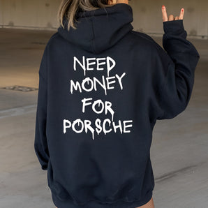 A person wearing a novelty black hoodie featuring a humorous Porsche design, ideal for car enthusiasts. The hoodie has long sleeves and a comfortable fit, suitable for casual outings. The individual is accessorized with sunglasses, adding to the fashion-forward look.
