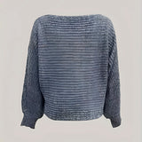 
A cozy off-shoulder sweater featuring cropped balloon sleeves, made from woolen knitwear in an electric blue color.