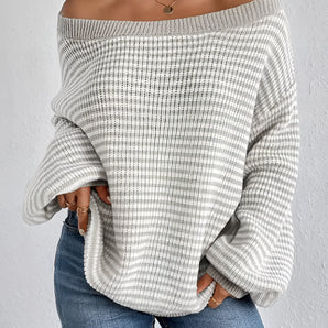 Oversized off-shoulder white knit sweater featuring long sleeves, showcasing a cozy and stylish fall fashion look.