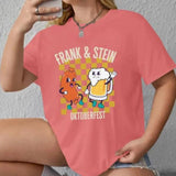 Oktoberfest-themed cartoon t-shirt featuring a whimsical design of "Frank & Stein" characters enjoying a beer festival, printed on a rose-colored fabric. The shirt is displayed in an XL size, with emphasis on the sleeves and neckline.