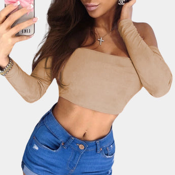 A woman wearing an olive green asymmetrical one-shoulder long sleeve crop top, highlighting the shoulder and waist area, with a focus on the stylish sleeve design.