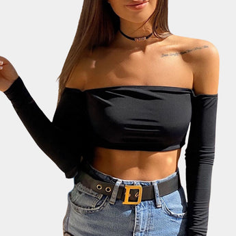 Olive green asymmetrical one-shoulder long sleeve crop top being modeled by a woman with long hair, showcasing the shoulder and waist design, emphasizing the fashion-forward style.