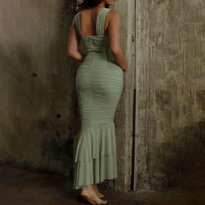 Olive green backless ruched mermaid dress featuring a ruffle hem, showcasing a form-fitting sheath style with a focus on the shoulders and waist.