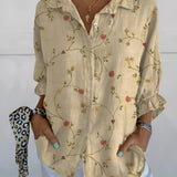 Olive green bird print V-neck blouse with ruffle sleeves for women, showcased in a stylish design, possibly worn with outerwear.