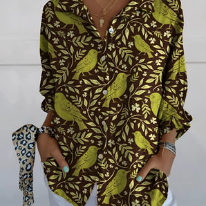 Olive green V-neck blouse with a bird print design, featuring ruffle sleeves. The blouse is designed for women and is shown in size 5XL.