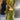 Olive green bohemian tiered midi dress in a vintage chic style, featuring a flowing design with a defined waist and long sleeves, modeled by a fashion model.