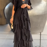 Olive green bohemian tiered midi dress with vintage chic design, featuring a flattering silhouette and comfortable fit, worn by a model showcasing the dress's flowy tiers and stylish full sleeves.