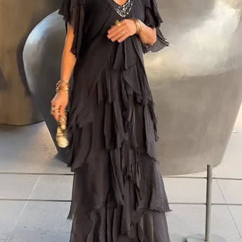 Olive green bohemian tiered midi dress with vintage chic design, featuring a flattering silhouette and comfortable fit, worn by a model showcasing the dress's flowy tiers and stylish full sleeves.