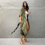 Olive green boho kimono dress with long sleeves, styled as lightweight summer beachwear, worn by a person with long hair.