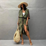 Olive green boho kimono dress worn by a woman, highlighting the lightweight and flowing fabric ideal for summer beachwear, with visible features including sleeves, waist, and knee-length design.