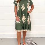 Olive green floral bohemian dress in size 5XL featuring a casual chic style suitable for summer festivals. The one-piece garment has a flattering day dress design with a defined waist, short sleeves, and a modest neckline.