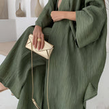 Olive green high-waisted pleated maxi skirt in a bohemian crinkled style, shown in size 3XL.
