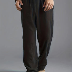 Unisex olive green lightweight harem pants styled as baggy summer trousers.