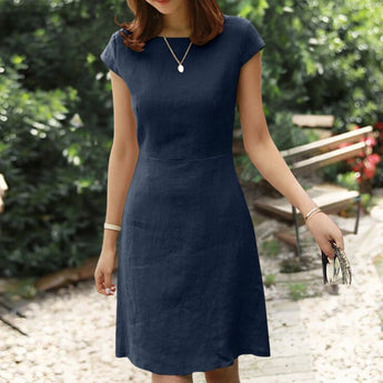 Olive green linen knee-length A-line dress featuring a V-neck and short sleeves, elegantly tailored to highlight the waist.