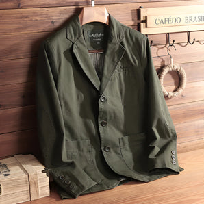 Olive green men's casual blazer hanging on a clothes hanger, featuring a classic collar and button closure, perfect for lightweight spring wear.