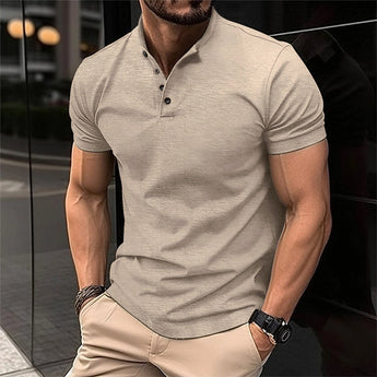 Olive green men's fitted polo shirt with short sleeves, styled for a casual smart look, shown in a khaki color and size 2XL, worn by a model with a beard wearing eyewear.