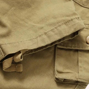 Olive green men's lightweight cargo shorts made from durable cotton with multiple pockets, displayed on a neutral background.