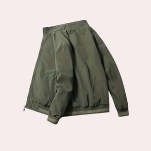 Olive green men's lightweight bomber jacket featuring a zippered pocket on the sleeve, designed with a subtle camouflage pattern.