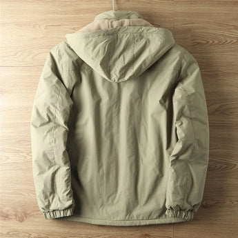 Olive green men's lightweight hooded windbreaker jacket hanging on a clothes hanger, showcasing its water-resistant material, long sleeves, and subtle design details.