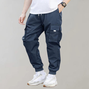 Olive green men's tapered cargo pants featuring a lightweight design ideal for utility fashion.