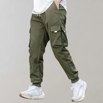 Olive green men's tapered cargo pants, featuring a lightweight design with utility fashion elements, including multiple pockets and a comfortable waist fit.