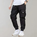 
A pair of olive green men's tapered cargo pants, showcasing a lightweight utility fashion design, with visible pockets and a modern fit.