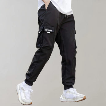 Olive green men's tapered cargo pants designed for lightweight comfort and utility fashion, shown on a model with emphasis on the knee and thigh area.