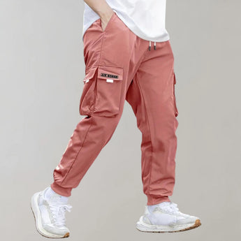 Olive green men's tapered cargo pants featuring a lightweight design suitable for utility fashion, with visible knee and thigh details.