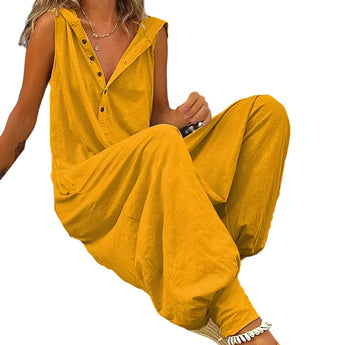 Woman wearing olive green sleeveless V-neck summer jumpsuit standing with arms slightly bent and legs visible.