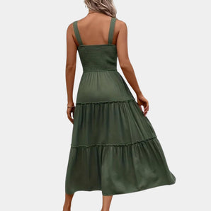 Olive green midi dress with a smocked bodice and thin shoulder straps, featuring a flowing skirt and designed for daytime wear.