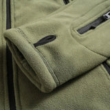 Olive green tactical fleece hoodie with a military-inspired design, featuring long sleeves, a full zip closure, and a high collar. The jacket is made of natural textile materials and includes insulated lining for warmth.