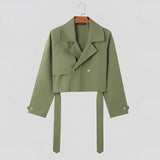 
A women's olive green cropped blazer featuring a tie-waist design, suitable for office settings. The blazer has long sleeves, a structured collar, and a tailored fit, blending professional style with contemporary fashion.