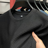 Olive green waffle knit sweater with long sleeves, featuring a unisex design for fall fashion. The sweater has a textured pattern, visible collar, and a cozy fit in a size 4XL.