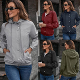 Olive green cropped utility jacket worn by a woman with long hair, wearing glasses and jeans.