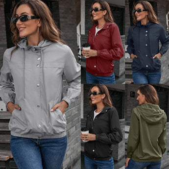 Olive green cropped utility jacket worn by a woman with long hair, wearing glasses and jeans.