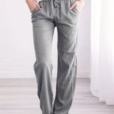 Woman wearing gray drawstring pants in 5XL size, showcasing lightweight, relaxed fit, and breathable fabric.