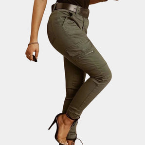 Olive green women's high-waisted skinny cargo pants with zipper, showcasing details such as multiple pockets, fitted design, and tapered legs.