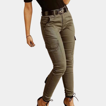 Olive green women's high-waisted skinny cargo pants with zipper, featuring a fitted design around the legs, styled with multiple pockets and a sleek zipper detail.