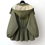 Olive green women's hooded cape jacket in a silk blend, featuring an elegant military style with a structured collar and button details.