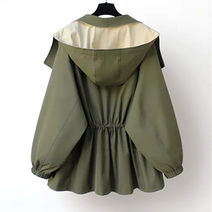 Olive green women's hooded cape jacket in a silk blend, featuring an elegant military style with a structured collar and button details.