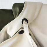 Olive green women's hooded cape jacket made from a silk blend with an elegant military style design, featuring a structured collar and silver-toned accents.