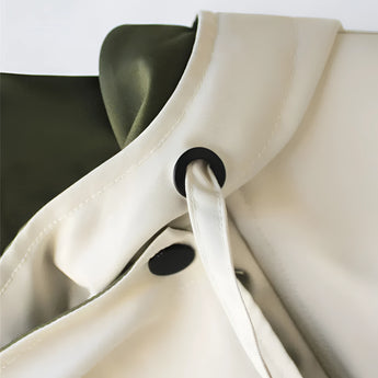 Olive green women's hooded cape jacket made from a silk blend with an elegant military style design, featuring a structured collar and silver-toned accents.